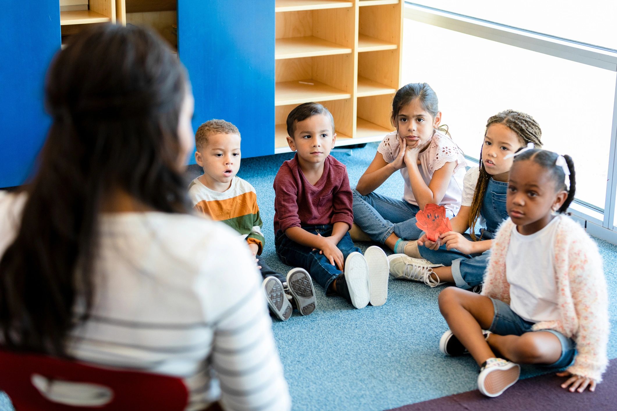 Children gathered for story time with a teacher