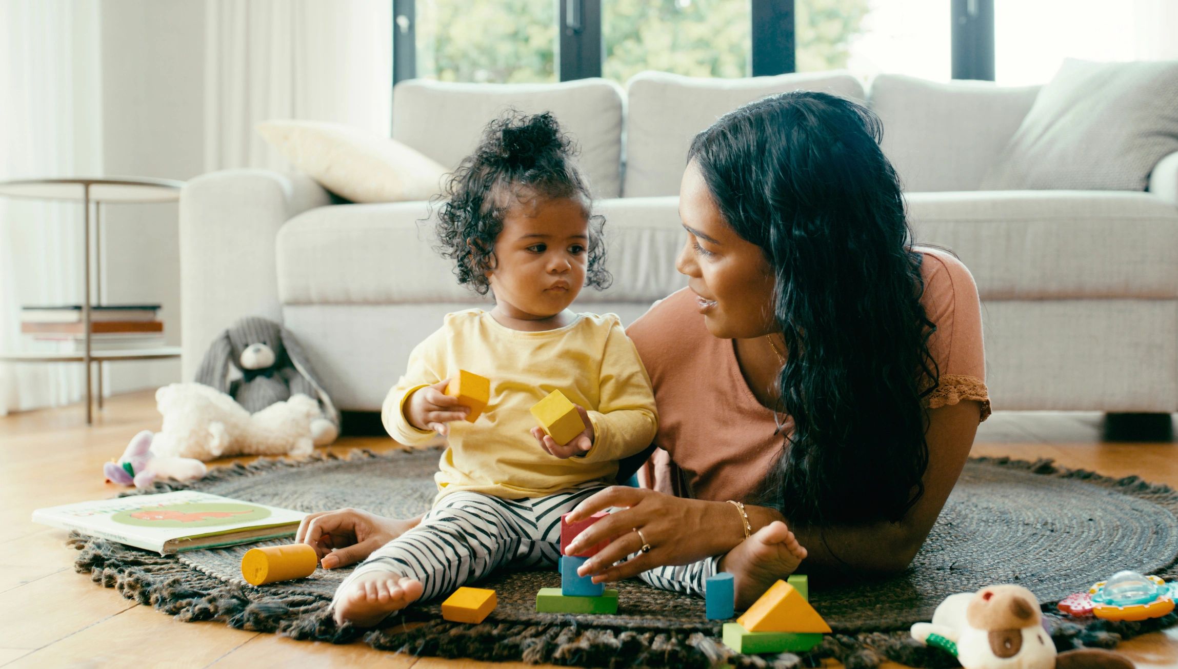 Parent and child playing with blocks on the floor