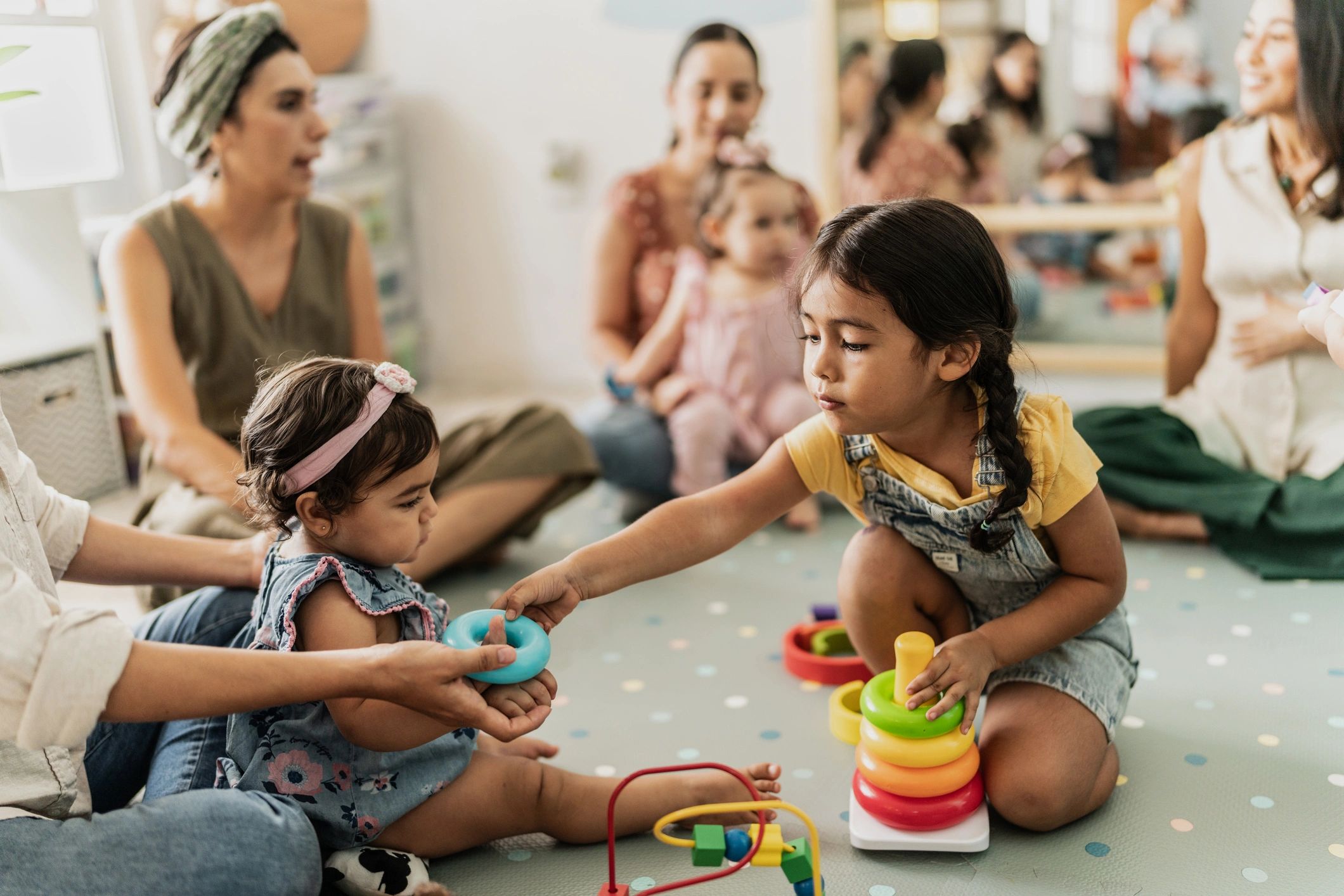 Young children playing together in a playroom