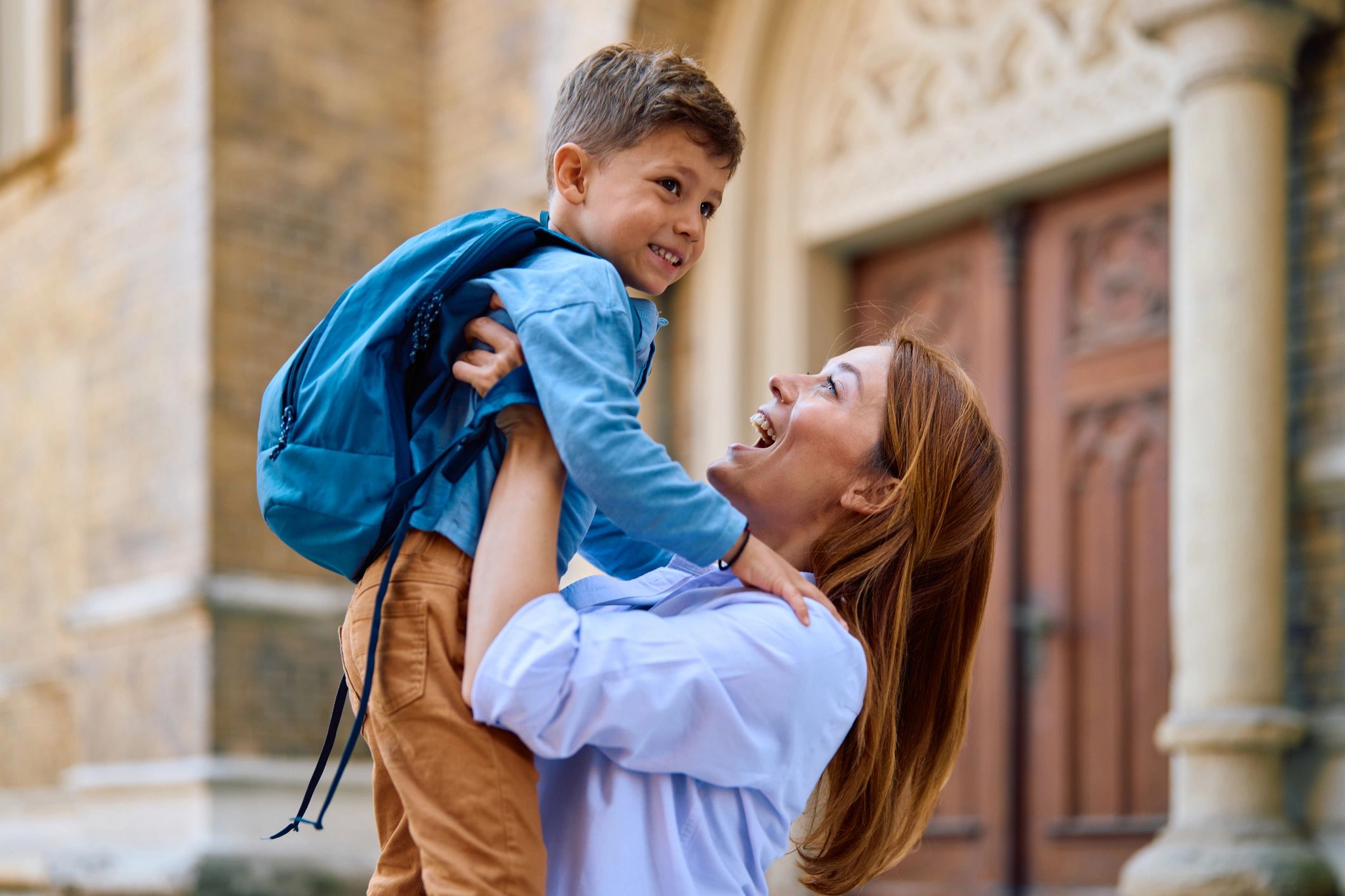 Mother lifting her child after school