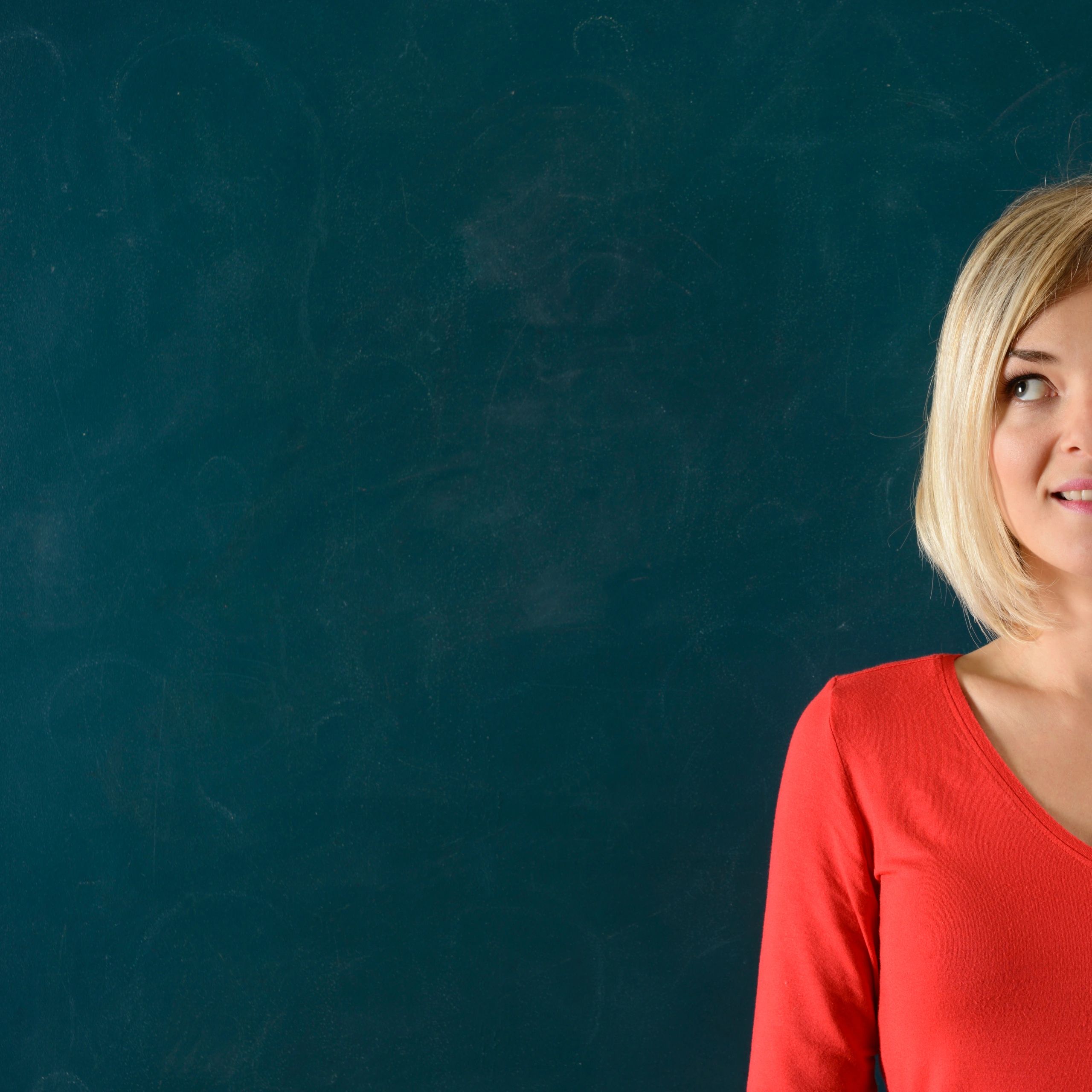 Portrait of an educator in front of a chalkboard